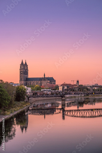 Colorful sunset in front of cathedral and old bridge in Magdeburg, Germany