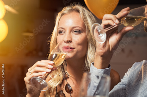 Beautiful woman drinking wine at party