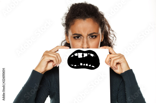 young african american woman with bad teeth drawn on paper on white background