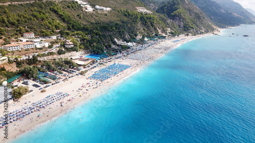 Aerial top view photo of sun beds in popular tropical paradise deep turquoise sandy beach of Kathisma, Lefkada island, Ionian, Greece