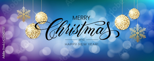 Merry Christmas background with blur bokeh light effect. Lettering Merry Christmas and Happy New Year