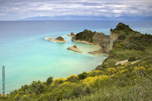 Beautiful summertime panoramic seascape. View from the cliff into the crystal clear azure sea . Corfu. Greece