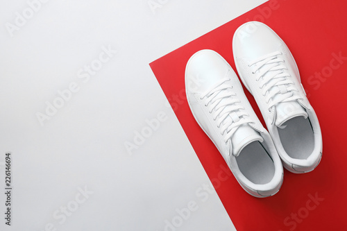 Pair of sneakers on color background, flat lay. Space for text