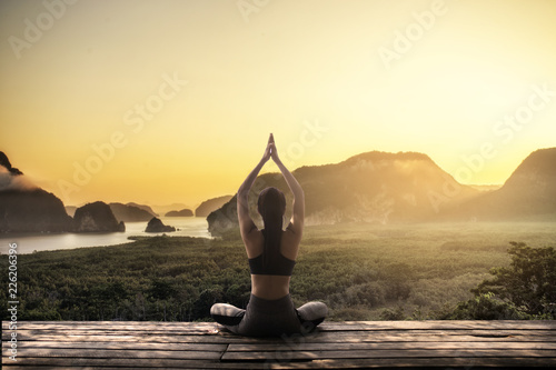 Young woman practicing yoga in the nature.female happiness.