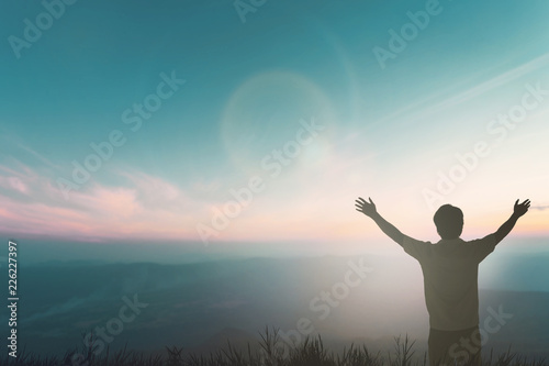 Happy man rise hand on morning view. Christian inspire praise God on good friday background. Now one man self confidence on peak open arms enjoying nature the sun concept world wisdom fun hope.