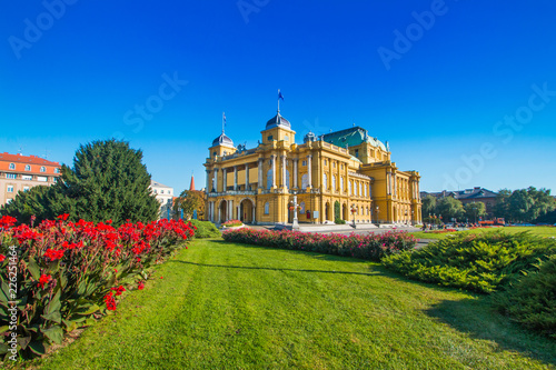  Croatian national theater building and flowers in park in Zagreb, Croatia 