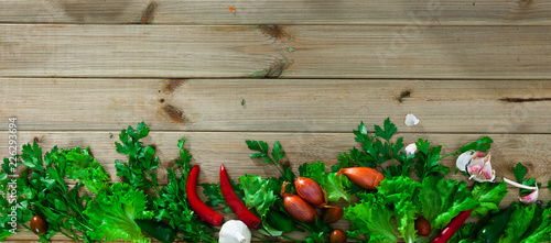 Natural wooden background with fresh vegetables assortment