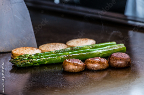 Mushrooms and asparagus on a Teppanyaki grill