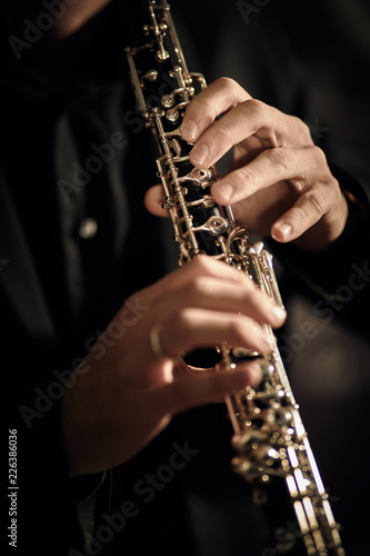 Oboe player on dark background musician