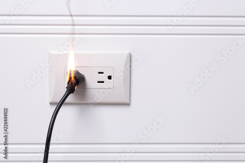 Overheated electric plug got on fire