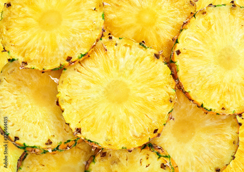 top view of sliced pineapple fruit as textured background