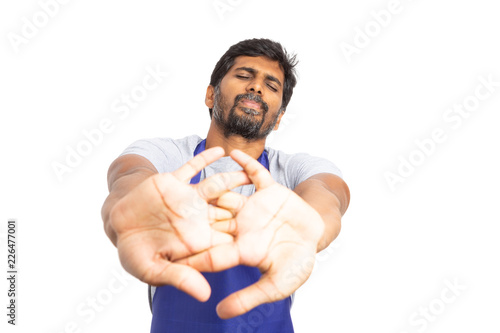 Supermarket employee stretching knuckles .