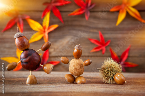 autumn tinker figures on wooden background