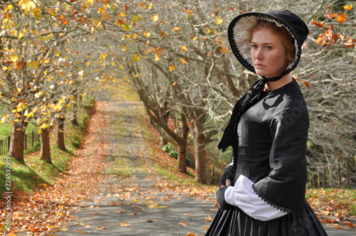 Victorian woman in autumn scene