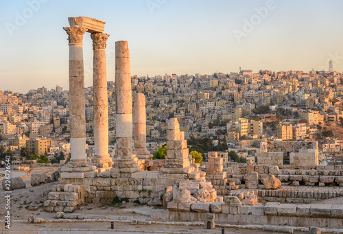 Amman, Jordan its Roman ruins in the middle of the ancient citadel park in the center of the city. Sunset on Skyline of Amman and old town of the city with nice view over historic capital of Jordan.