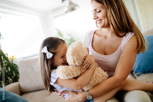 Mother and daughter portrait with teddy bear