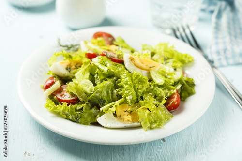 Fresh green salad with tomatoes and hard boiled egg