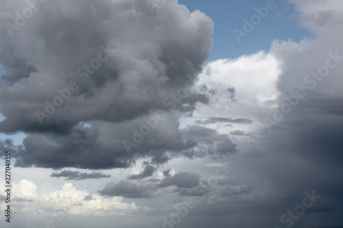 View on an impressive, beautiful, stormy cloudscape, with wonderful shades of grey and white against a blue sky