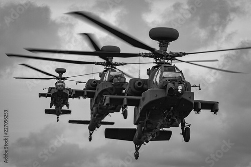 A line of three WAH-64 Apache Longbow attack helicopters coming into land, RAF Shawbury, Shropshire