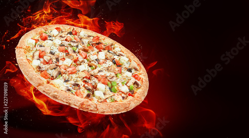 hot fresh traditional italian pizza in flames