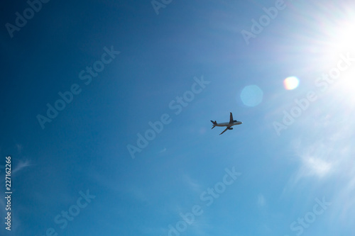 passenger airplane taking off into the sun