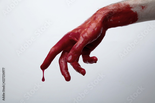 Bloody hand against a light background. halloween horror concept