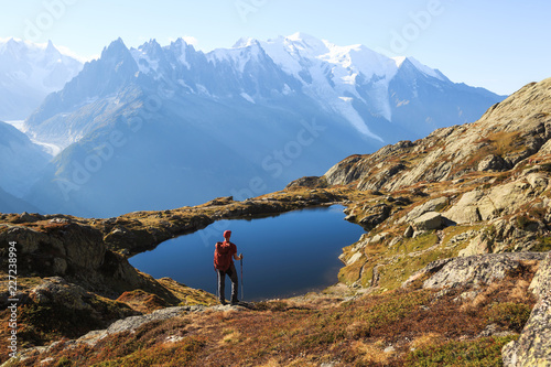 Hiker looking at Lac des Cheserys on the famour Tour du Mont Blanc near Chamonix, France.