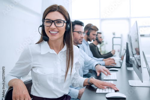 smiling call center employee works in a modern office