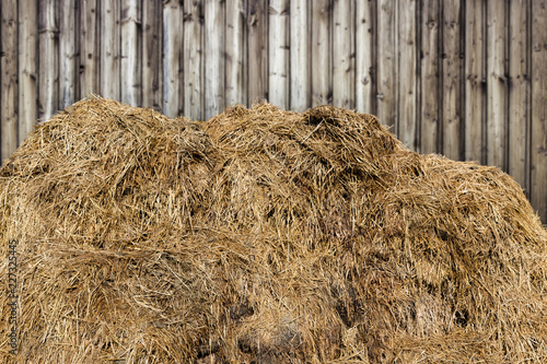 dunghill or muckheap with wooden background