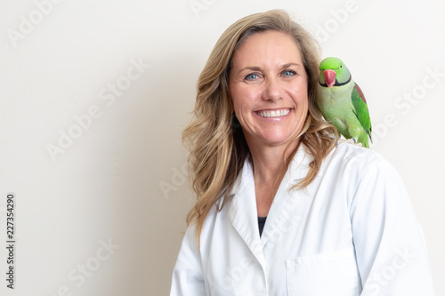Friendly Female Veterinarian With Bird on Shoulder
