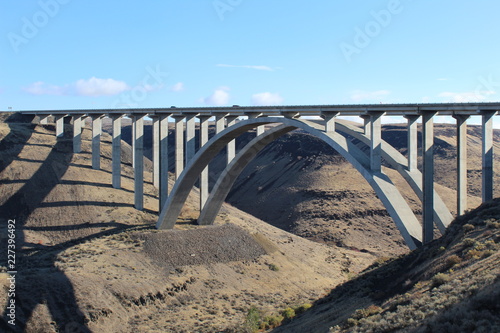 Fred G. Redmon bridge over the Selah creek outside Yakima , Washington. its a beautiful bridge between the canyon with a arch support below in concrete. Blue sky and and clouds in the sky .