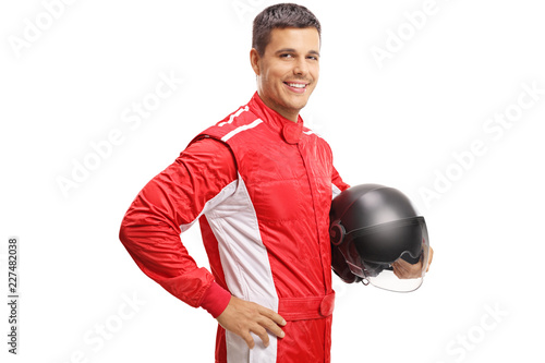 Racer holding a helmet and smiling