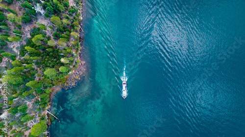 Drone view of the shore with a boat crossing at Lake Tahoe California