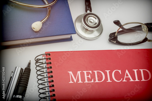 Titled red book medicaid along with medical equipment, conceptual image