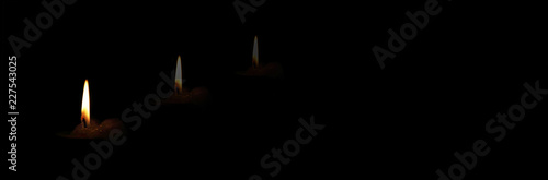 The concept of mourning. Candle on a dark background and reflection. We remember, we grieve. Selective focus, place for text. Banner