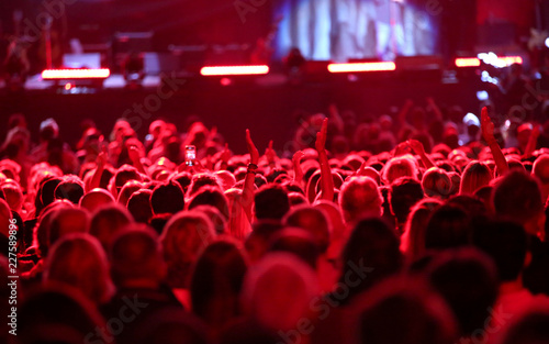 red lights on the heads of people during a concert
