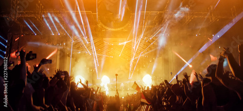 Crowd at concert and blurred stage lights with fireworks