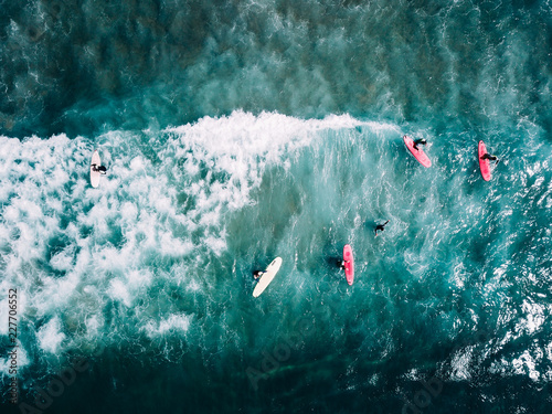 surfer waiting on beach for the next big wave in porto, portugal