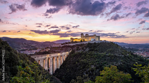 Spoleto on sunset. Ponte delle torri medieval bridge and Rocca Albornoziana hilltop fortress, Province of Perugia, Italy