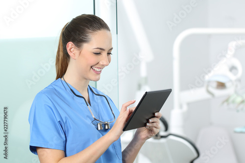 Dentist consulting online information in a tablet