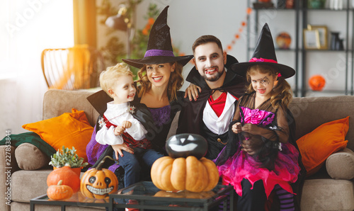happy family mother father and children in costumes and makeup on Halloween