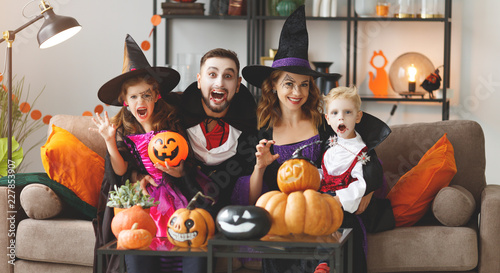 happy family mother father and children in costumes and makeup on Halloween