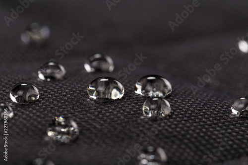 Water drops on waterproof black fabric