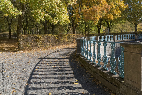 A historic fence in an autumn park.