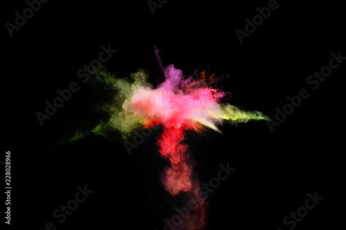 Bizarre forms of powder paint and flour combined together explode in front of a black background to give off fantastic multi colored cloud forms.