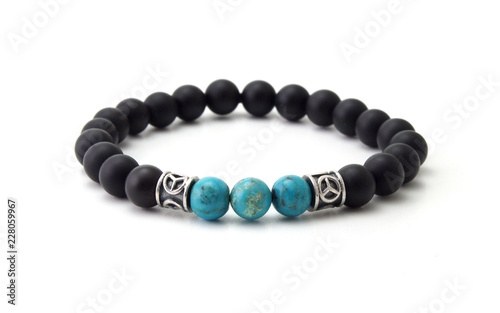 Unpolished black onyx bracelet with turquoise beads isolated on white background