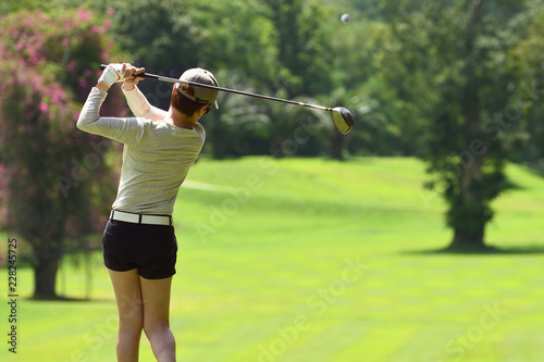 Woman playing golf on a beautiful natural golf course