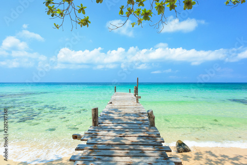 Long wooden bridge go to the sea in beautiful tropical island, Thailand.