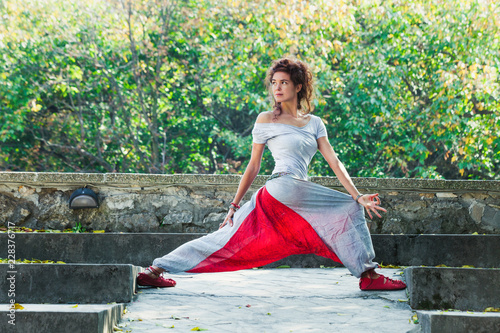 young woman practice yoga outdoor autumn day