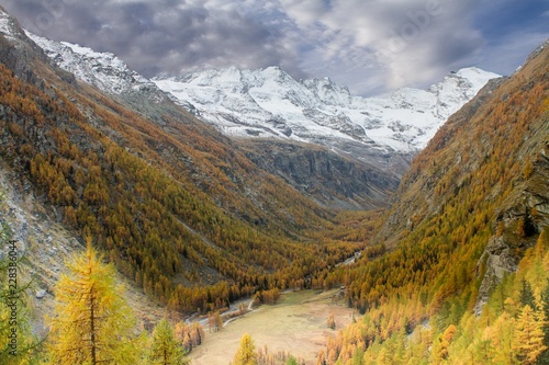 Great view of valley in Gran Paradiso National Park, Alps, Italy, dramatic scene, beautiful world. colourful autumn and mountains covered by snow,scenic view with cloudy sky, wallpaper
